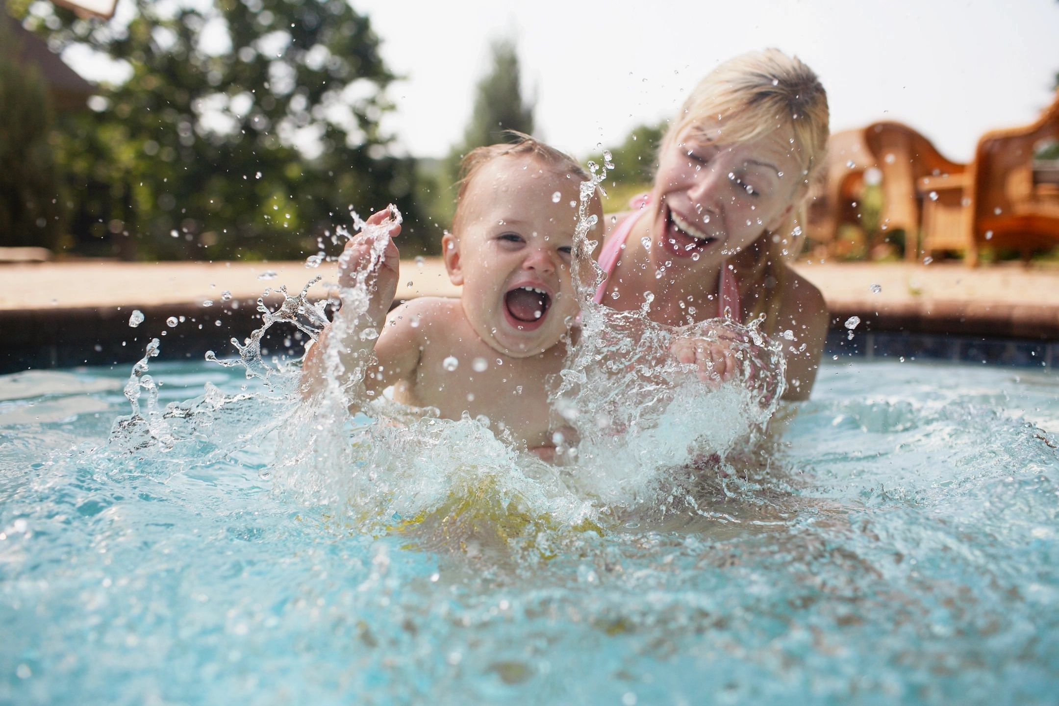 Nanny safely teaching child how to swim