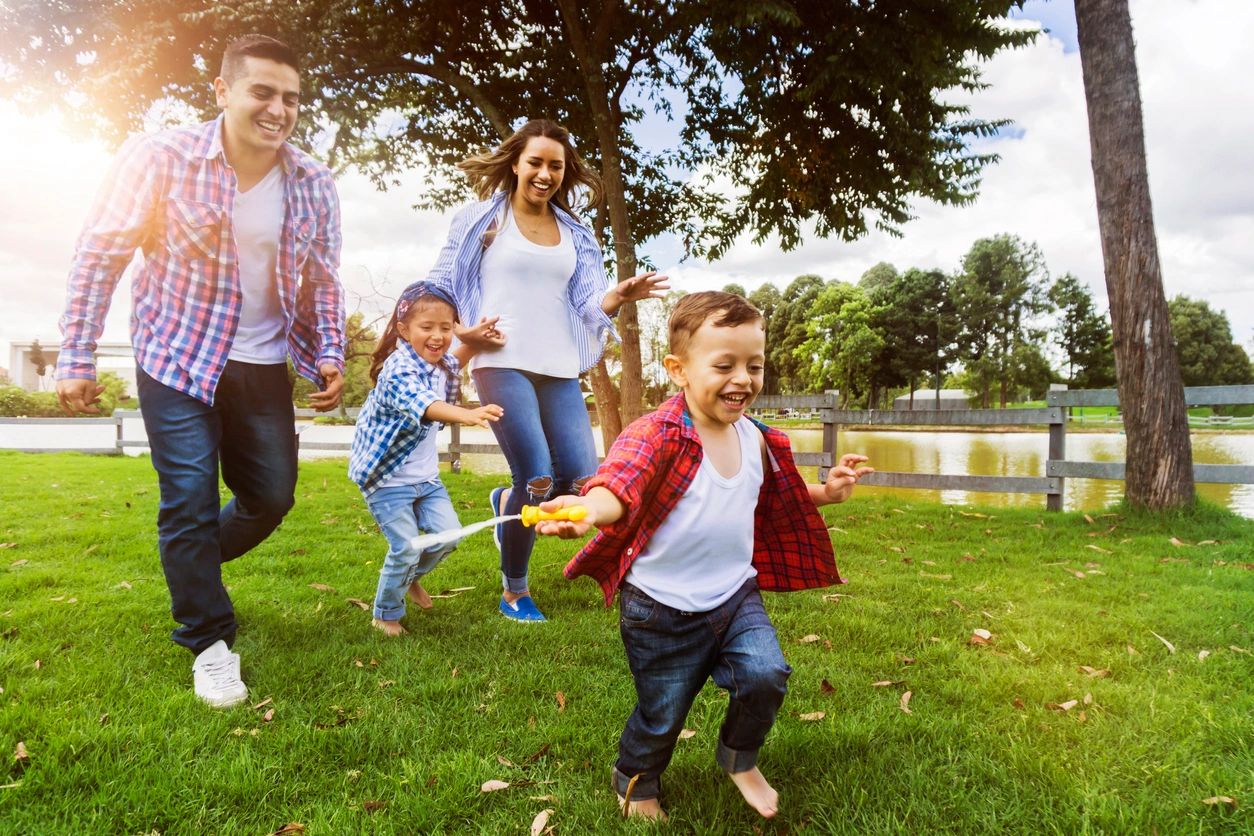 Happy family running through yard